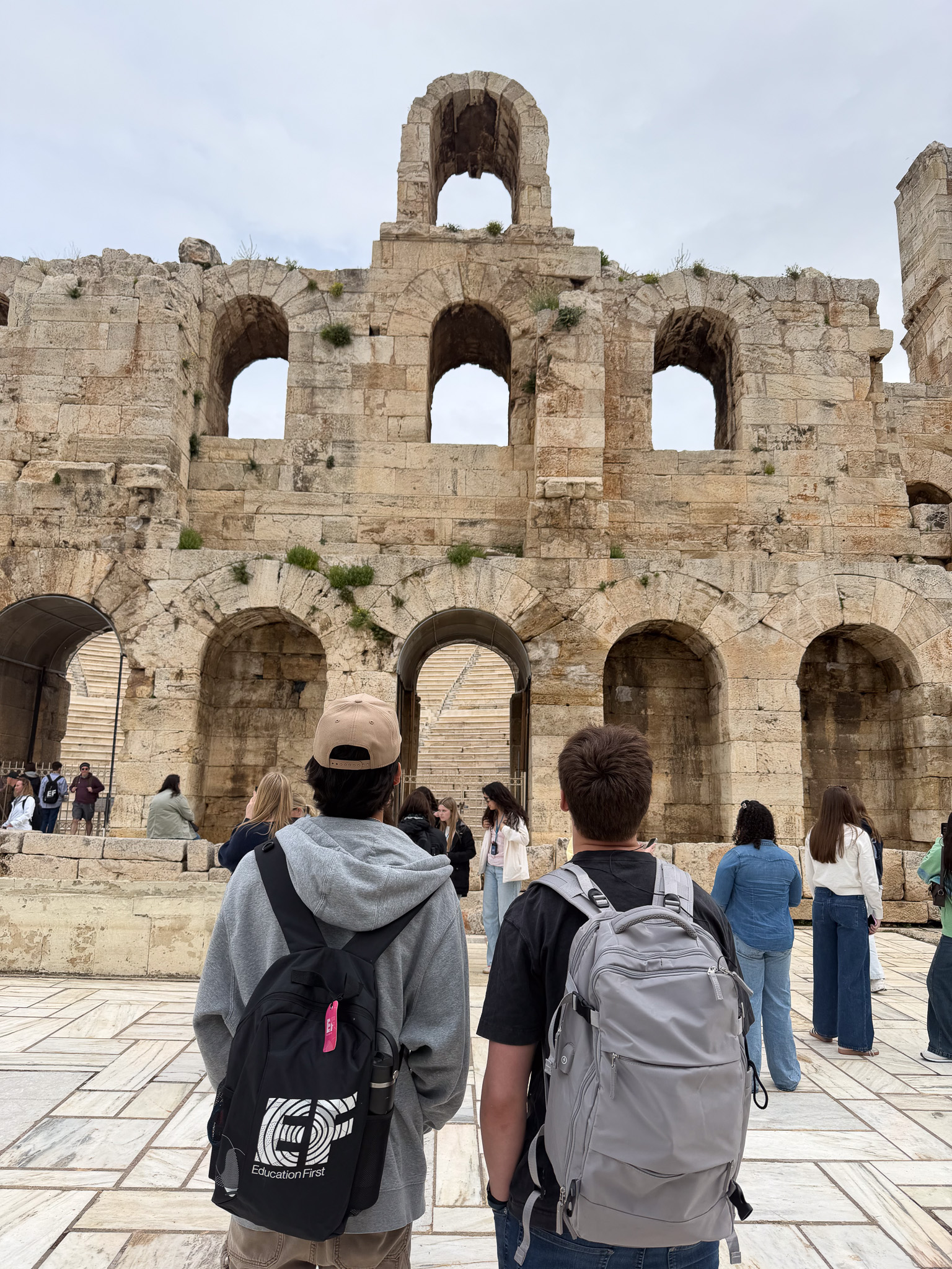 Students posing by ancient columns in Athens.