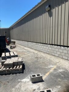 Placed masonry CMU blocks at the south side of bus garage the week of May 31-June 3, 2022.