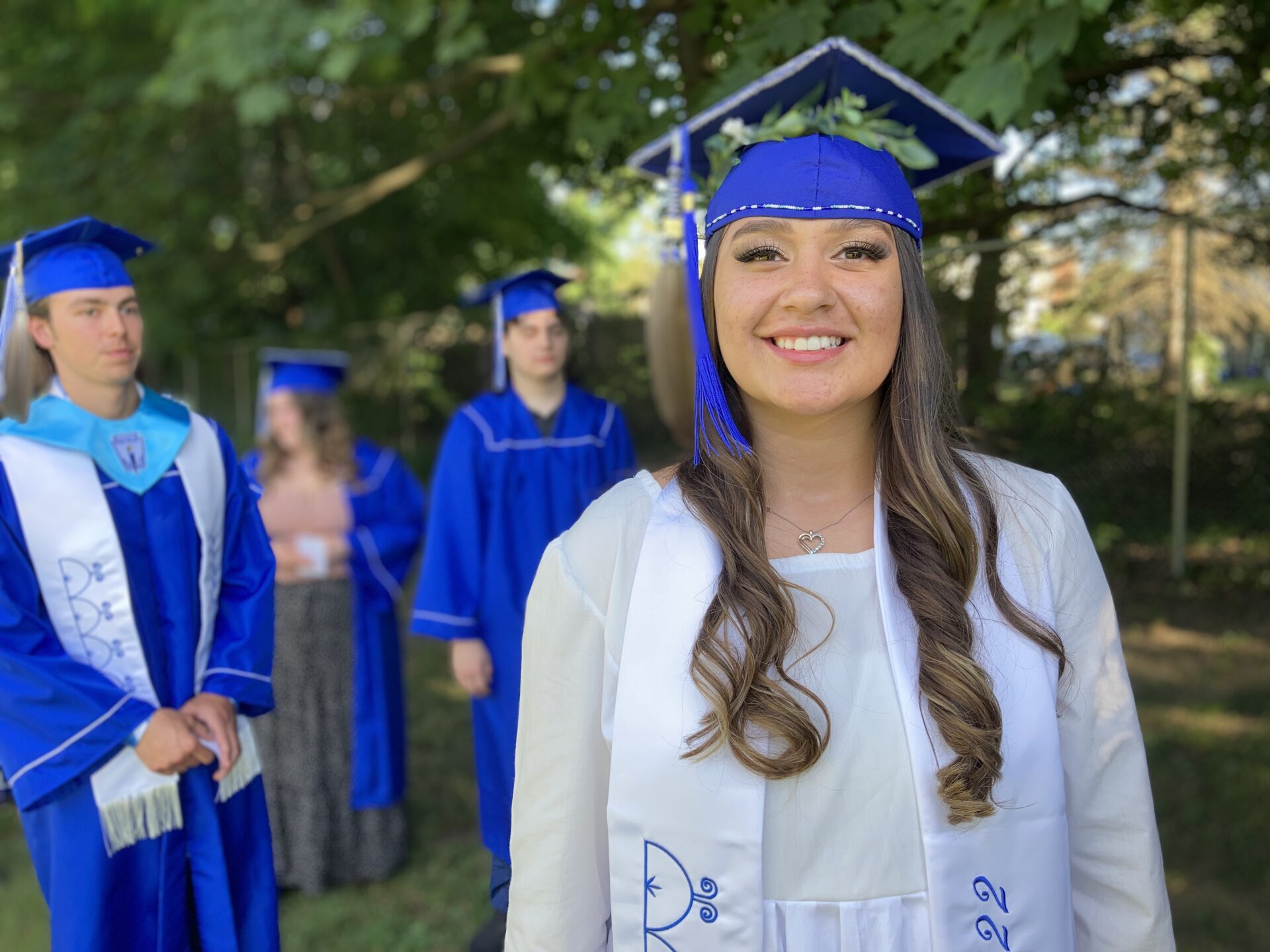 A graduate wears Native American regalia to graduation 