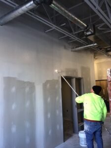 Priming the walls in the music room during the week of January 17-21, 2022.
