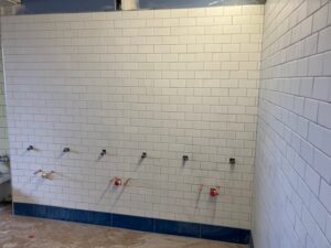 Grouting wall tile in bathroom at MS/HS on second floor week of Aug. 15-19, 2022.