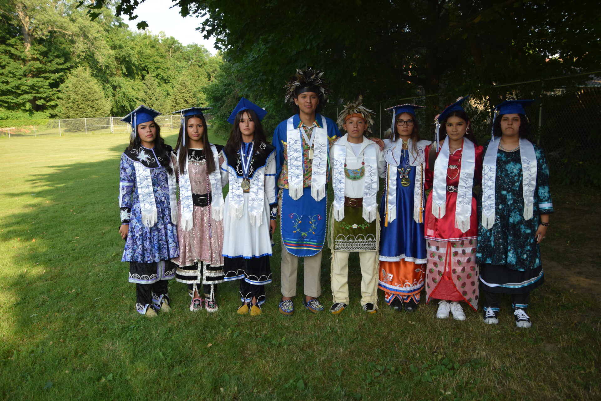 Smiling students in Native American dress 